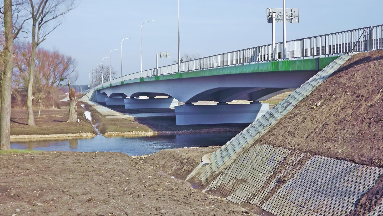 Zdjęcie przedstawia most w Trawnikach wraz z rzeką Wieprz.
