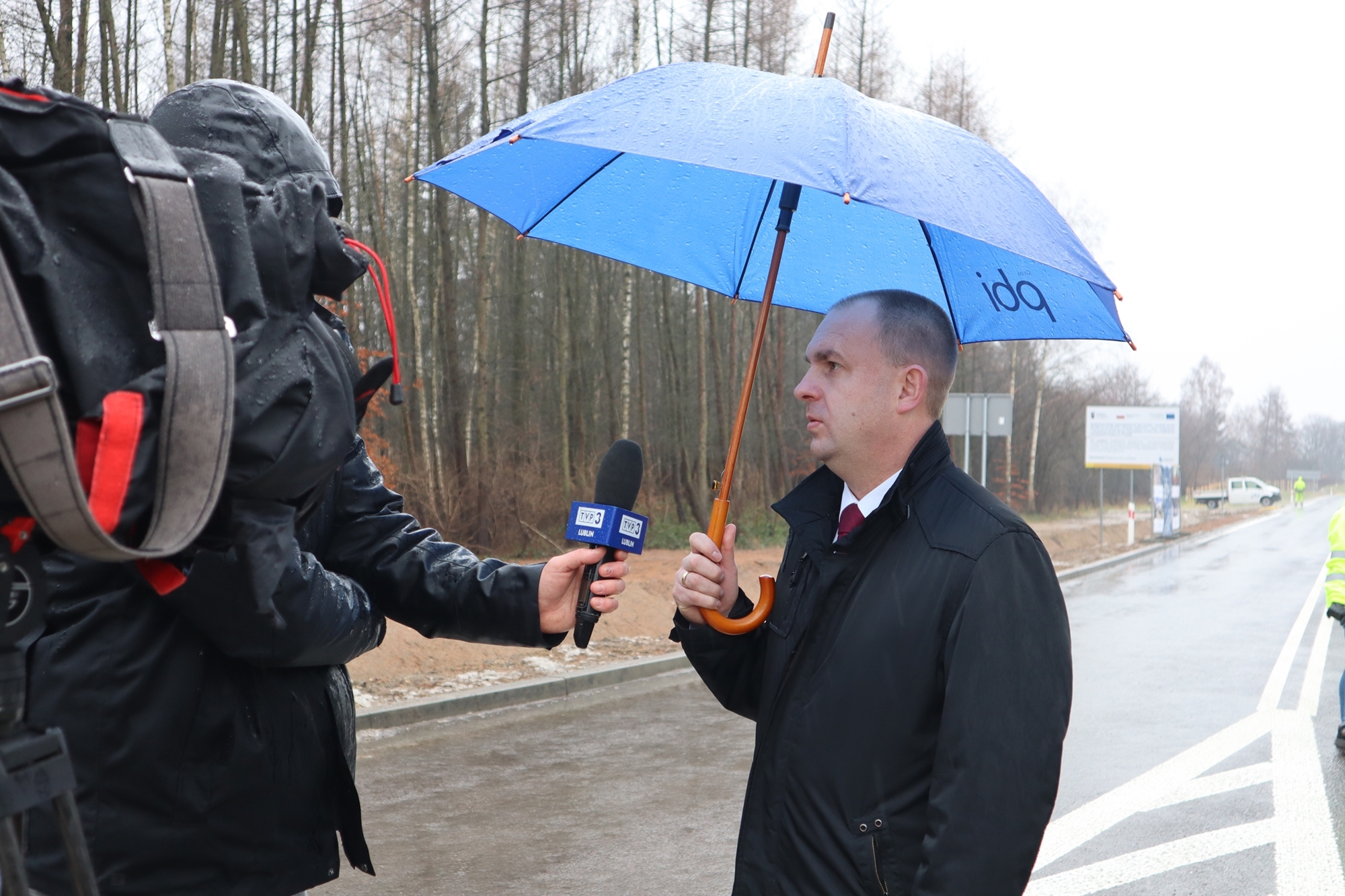Na zdjęciu widzimy dyrektora Zarządu Dróg Wojewódzkich w Lublinie Pawła Szumerę, który trzymając w ręku parasolkę, udziela wywiadu Telewizji Lublin